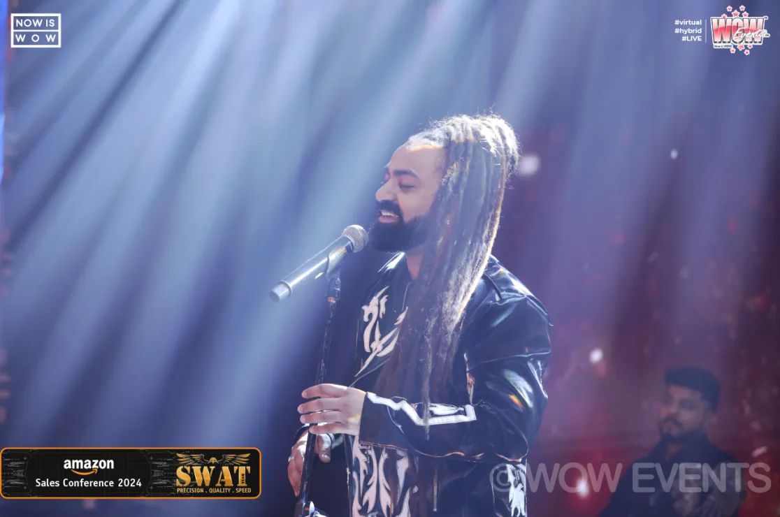 Singer with dreadlocks performing at Amazon Sales Conference 2024