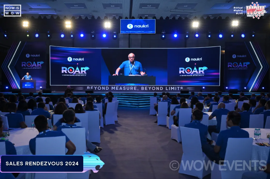 Naukri ROAR Sales Rendezvous 2024 hall with speaker on screen