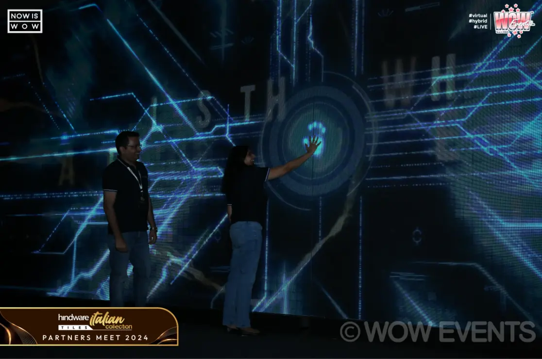 Guests at an interactive projection wall at the Hindware partners meet