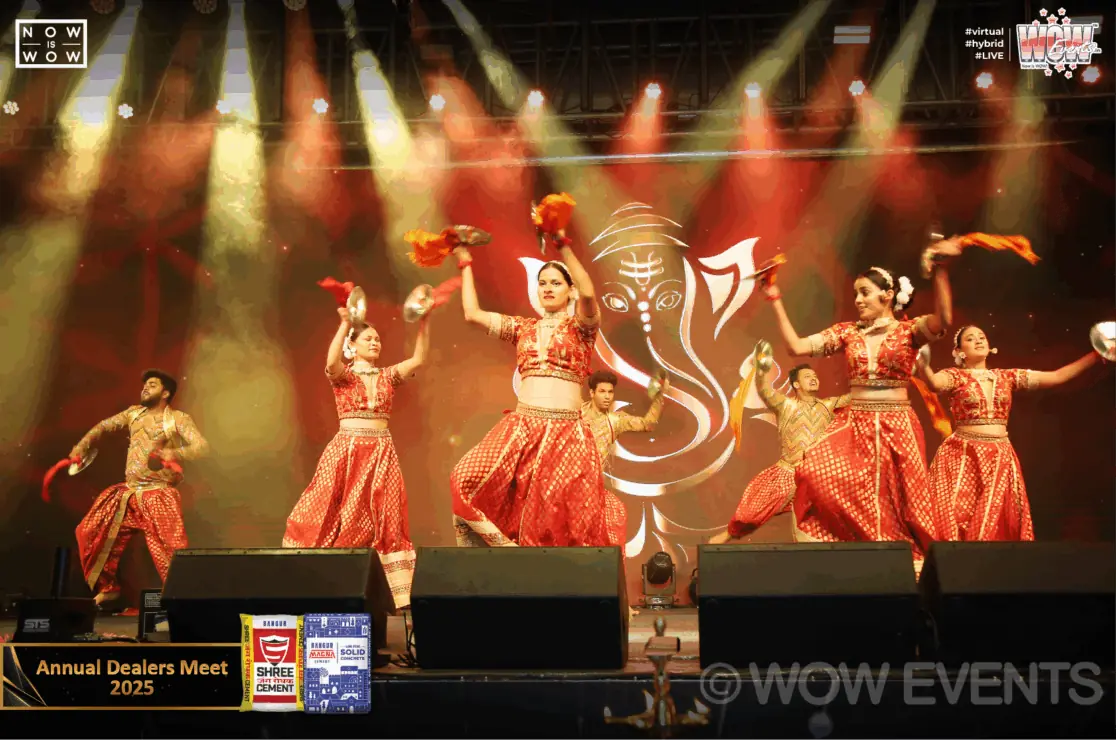 Dancers performing in red costumes at the Shree Cement dealers meet