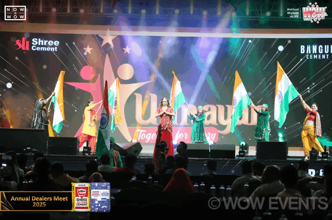 Performers waving Indian flags on the Unnayan stage