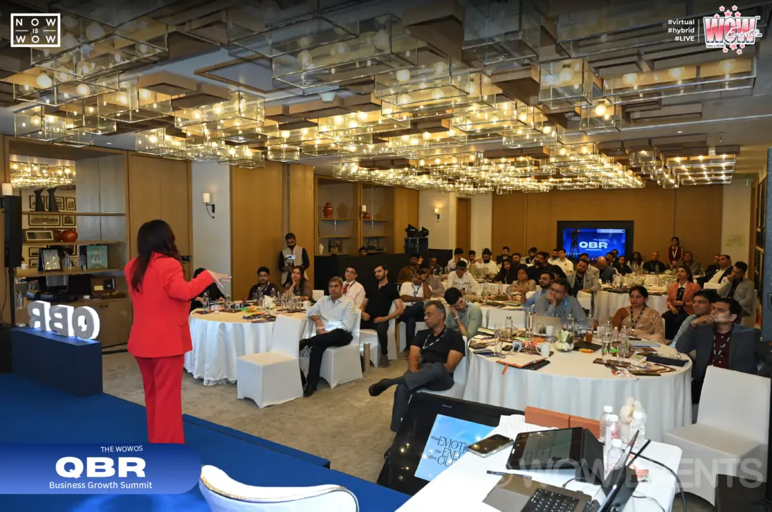 QBR business conference speaker in a ballroom
