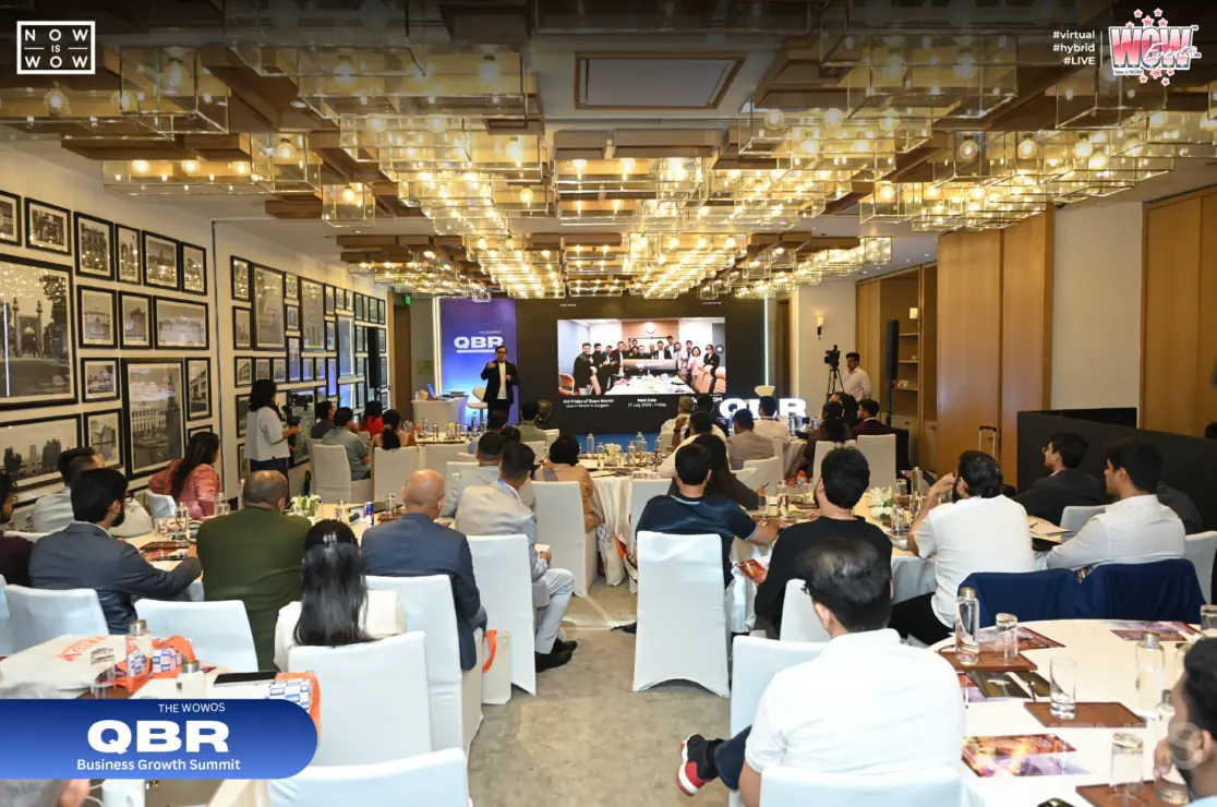 QBR business conference attendees at round tables