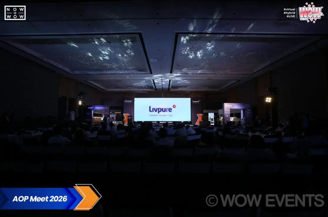 Livpure AOP Meet 2026 darkened hall with stage screen