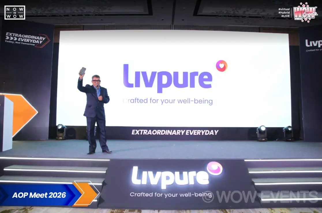 Speaker on stage under Livpure screen at AOP Meet 2026
