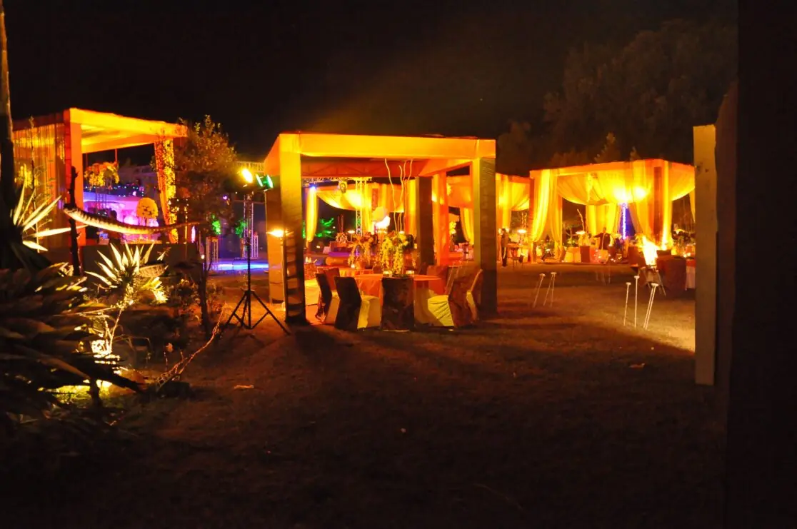 Lit outdoor seating gazebos at the cocktail wedding