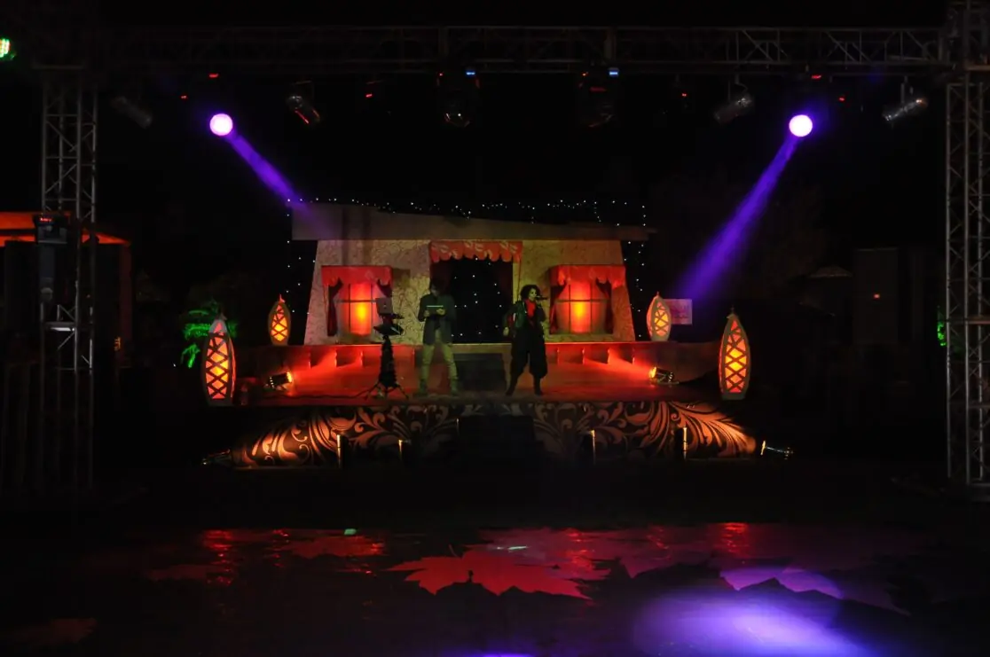 Outdoor stage with purple lights at night
