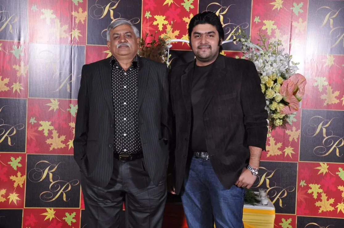 Two guests posing at the monogrammed backdrop