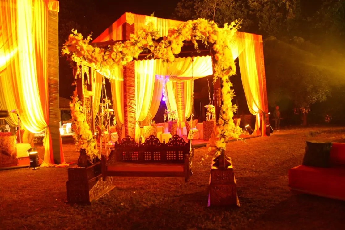 Lit floral mandap at the wedding venue at night
