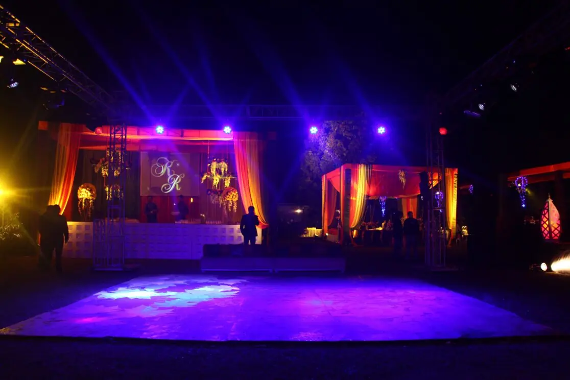 Outdoor wedding venue lit with purple lights