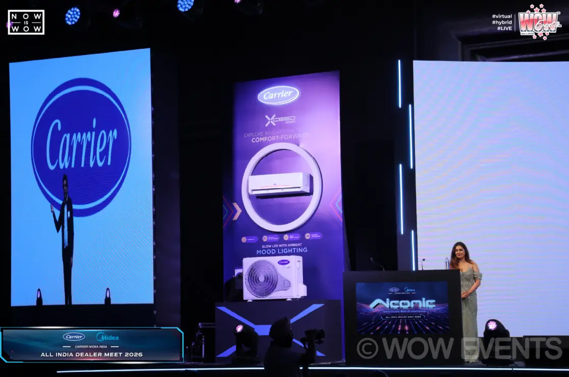 Host beside Carrier product displays on stage