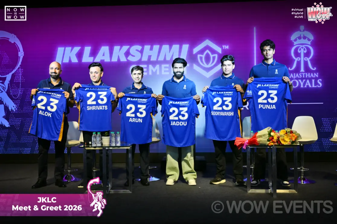 Cricketers holding number 23 jerseys on stage in Jaipur