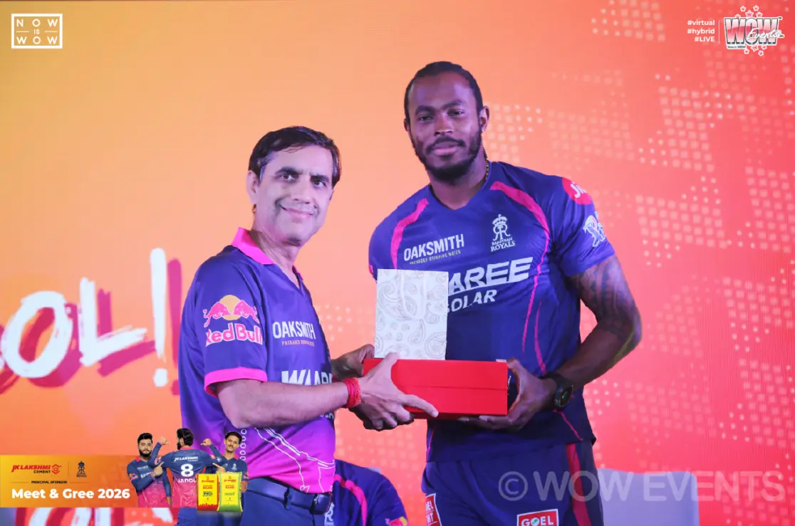 Cricketer receiving a gift on stage at JK Lakshmi Cement meet and greet