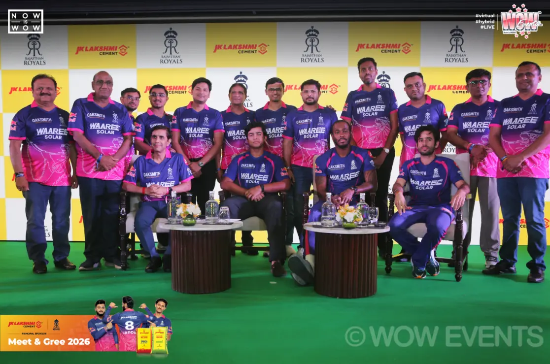 Cricketers and JK Lakshmi Cement team group photo on stage