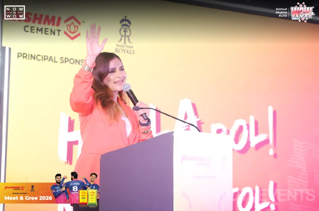 Host speaking at a podium at JK Lakshmi Cement meet and greet