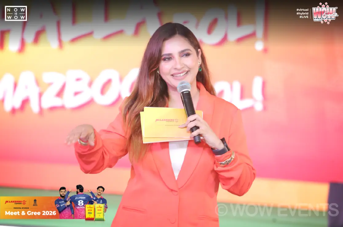 Host with a microphone at the JK Lakshmi Cement meet and greet