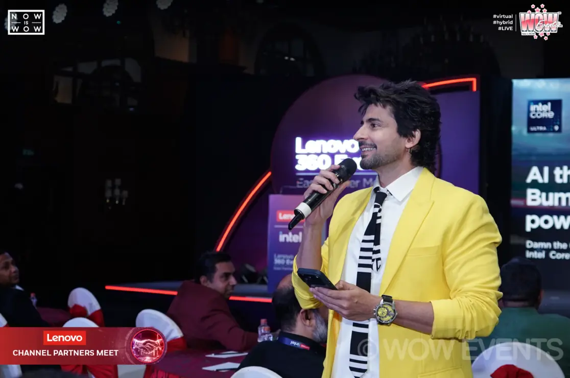 Host in a yellow blazer at the Lenovo dealers meet