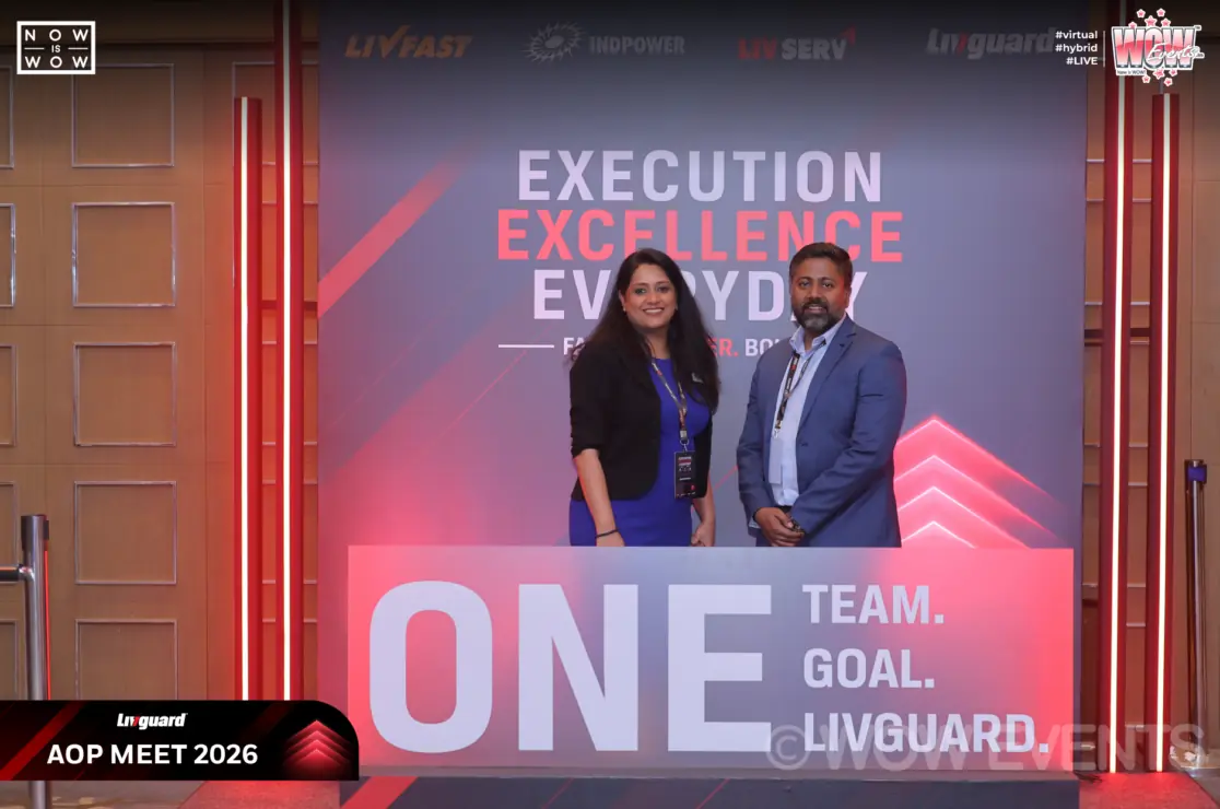 Livguard executives on stage behind the One Team sign