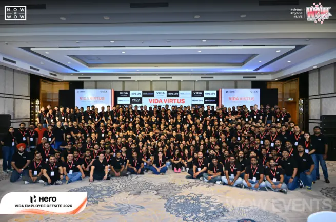 Hero Vida employee offsite group photo in a large hall