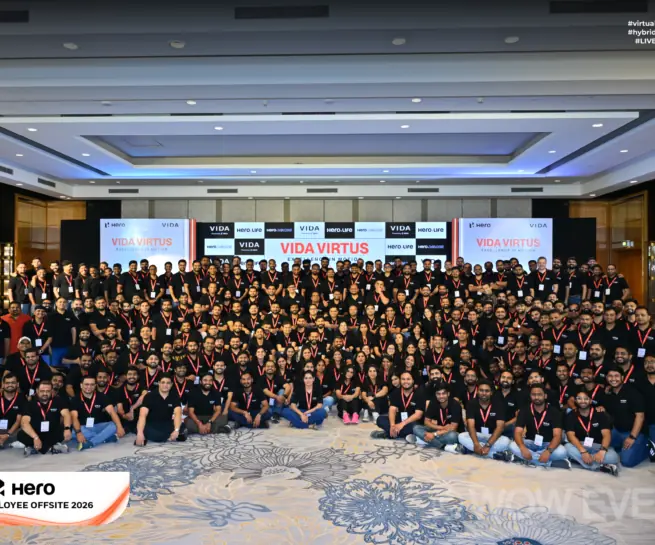 Hero Vida employee offsite group photo in a large hall