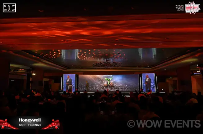 Honeywell event hall with stage screens and seated audience