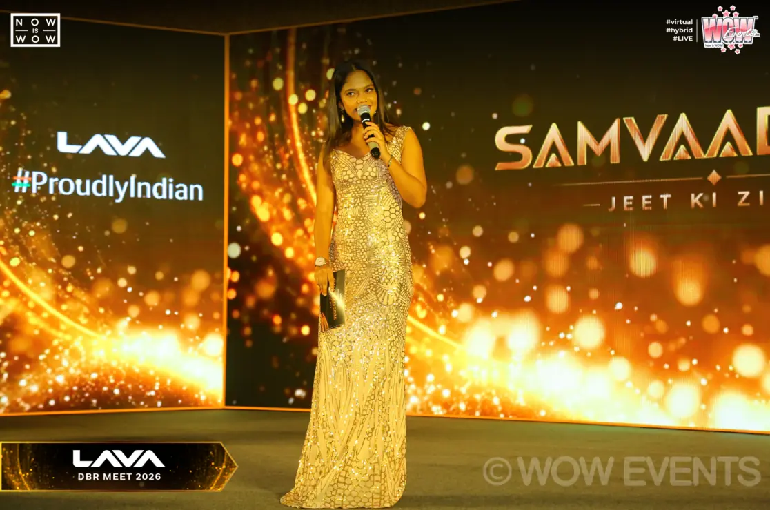 Singer in a gold gown performing at Lava Samvaad 2026