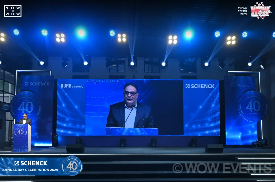 Schenck annual day speaker on stage screen
