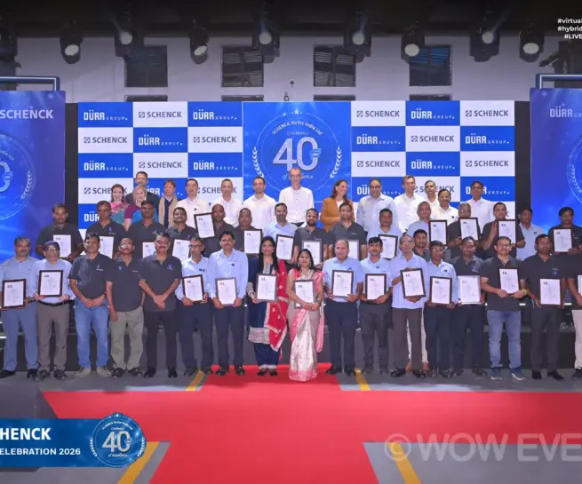 Schenck 40 years celebration group photo on stage with certificates